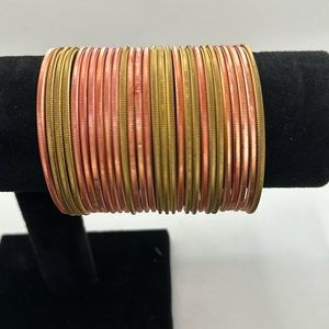 Pink and gold metal bracelets